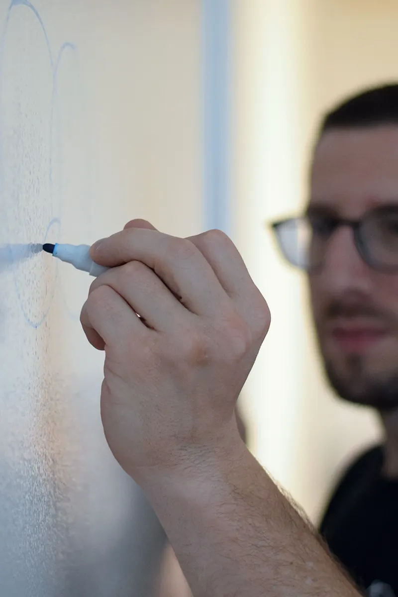 Requirements being structured at a whiteboard during a discovery workshop
